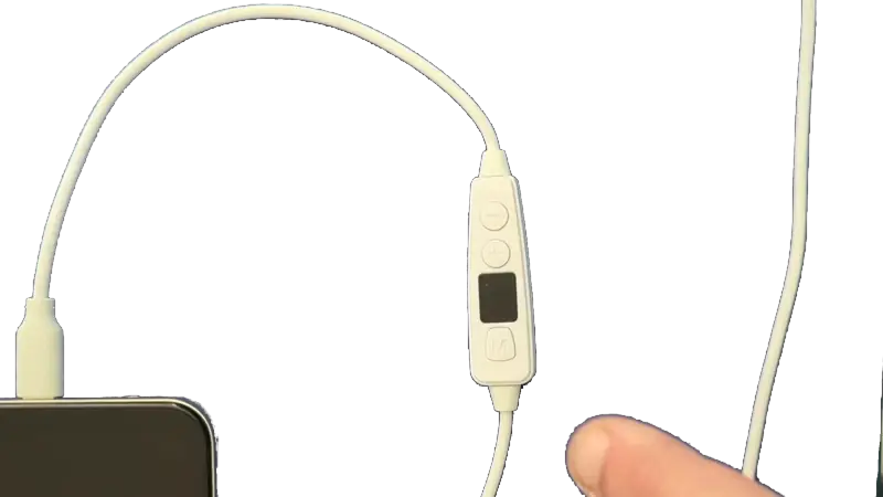A finger presses and holds the M button on the Vagal Boost for about two seconds, one Mississippi, two Mississippi, until the display lights up