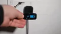 Hand plugging USB charger into wall outlet showing how to charge Vagus.net device