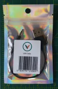 USB charging cable in holographic retail packaging with Vagus.net logo and barcode