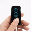 Finger pressing Vagal Buddy tVNS device button showing 5-minute timer with USB-C cable connected against white background
