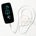 Vagal Buddy tVNS device showing a 15-minute session timer, cabled to its ear clip electrode fitted on a model ear
